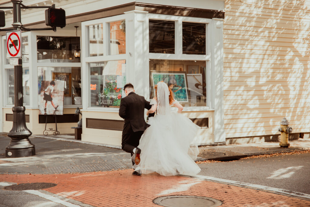 downtown charleston newlyweds running down the street