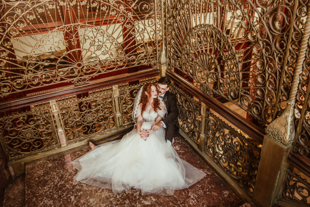 newlyweds sitting on the floor in the broad st post office in Charleston
