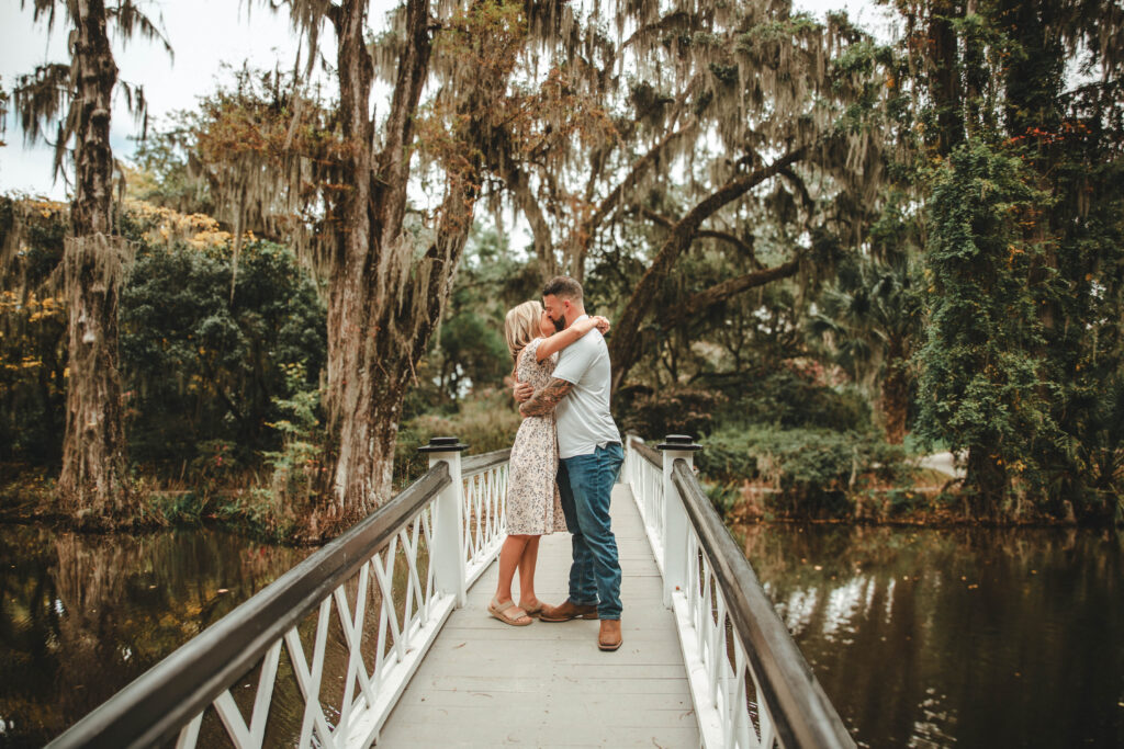 couple kissing on the white bridge at Magnolia Plantation