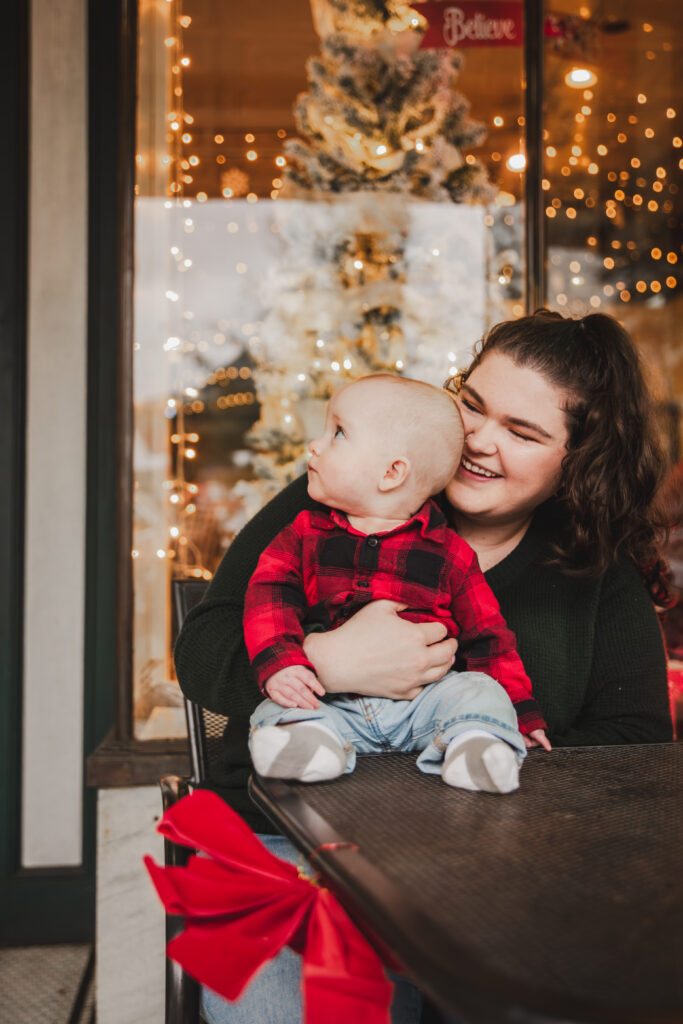 mom and baby with twinkling lights in the background