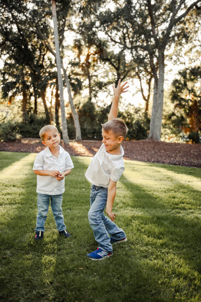 2 young brothers goofing around in a field at Kiawah Island Resort

