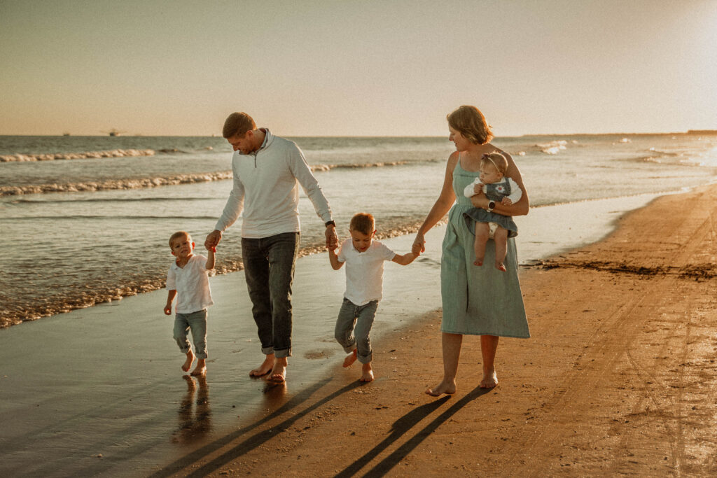 family walking down the beach at sunset on Kiawah Island
